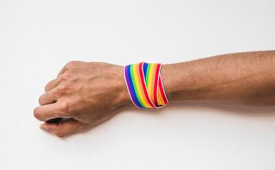 Male hand with band in LGBT colors