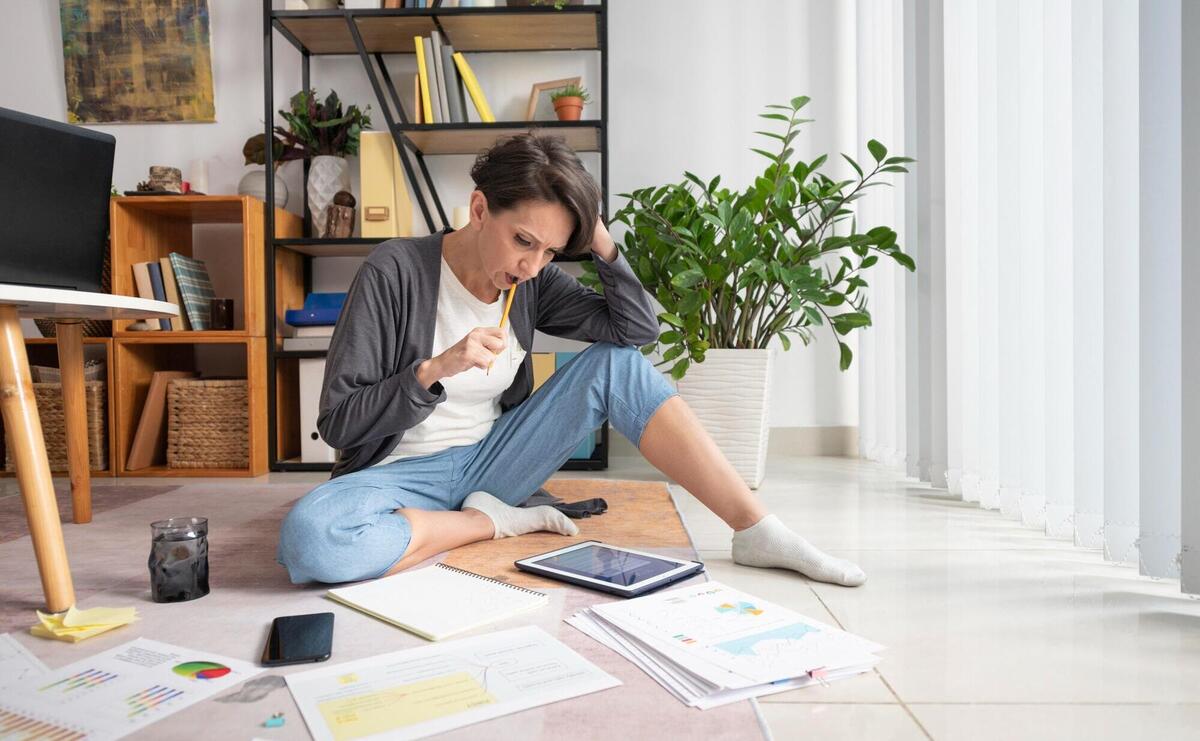 Woman preparing for meeting with tablet.